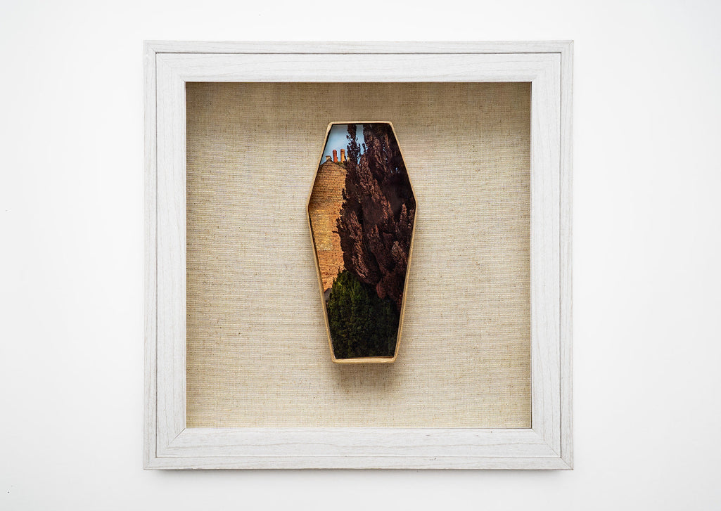 coffin shaped artwork in a frame